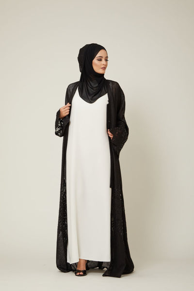 white slip dress with black open abaya