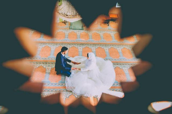 view of bride and groom holding hands